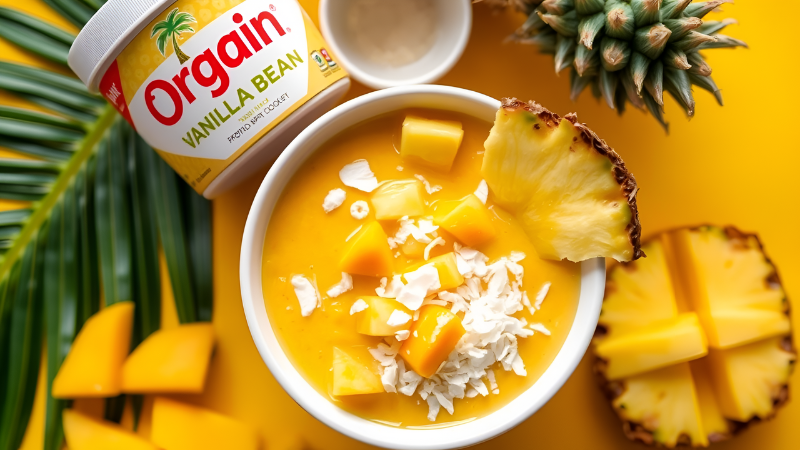"Tropical Vanilla Protein Bowl with Orgain Vegan Protein Powder topped with mango and coconut in a bowl."
