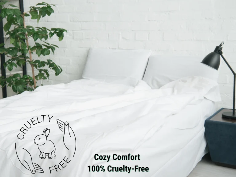 White bed with vegan duvet cover, cozy pillows, and potted plant – cruelty-free and eco-friendly bedroom decor.
